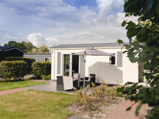 Relax in this luxury 4 person chalet on a quiet holiday park in Rijsse...