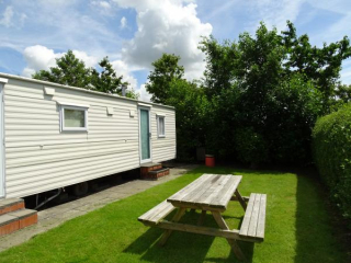 Cozy 6-person mobile home at a pleasant mini-camping in Kerkwerve
