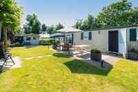 4 persons chalet with fenced garden on the edge of a small park in Goe...